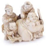 ˜IVORY NETSUKE OF THE LUCKY GOD HOTEI WITH CHILDREN, CIRCA 1870 seated in the mouth of his