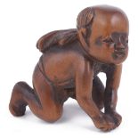 WOOD NETSUKE OF A CRAWLING BABY BOY, CIRCA 1860 unsigned 3.7cm high Provenance: The Netsuke