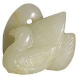 A CHINESE CELADON JADE GOOSE AND GOSLING carved side by side, recumbent with legs tucked under the