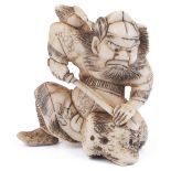 ˜IVORY NETSUKE OF SHOKI THE DEMON QUELLER, CIRCA 1870 sharpening his sword on a rock, extensive