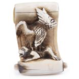 ˜IVORY NETSUKE OF A HANGING SCROLL COMING TO LIFE, CIRCA 1850 an eagle attacking a monkey,