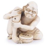 ˜IVORY NETSUKE OF A MAN APPLYING MOXA, CIRCA 1870 his eyes smarting from the pain of the burning