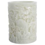A CHINESE CELADON JADE 'LANDSCAPE' BRUSHPOT the cylindrical body rising from a slightly recessed
