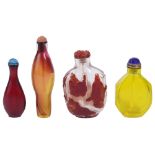 A STUDY COLLECTION OF FOUR CHINESE GLASS SNUFF BOTTLES comprising: a red overlay clear glass '