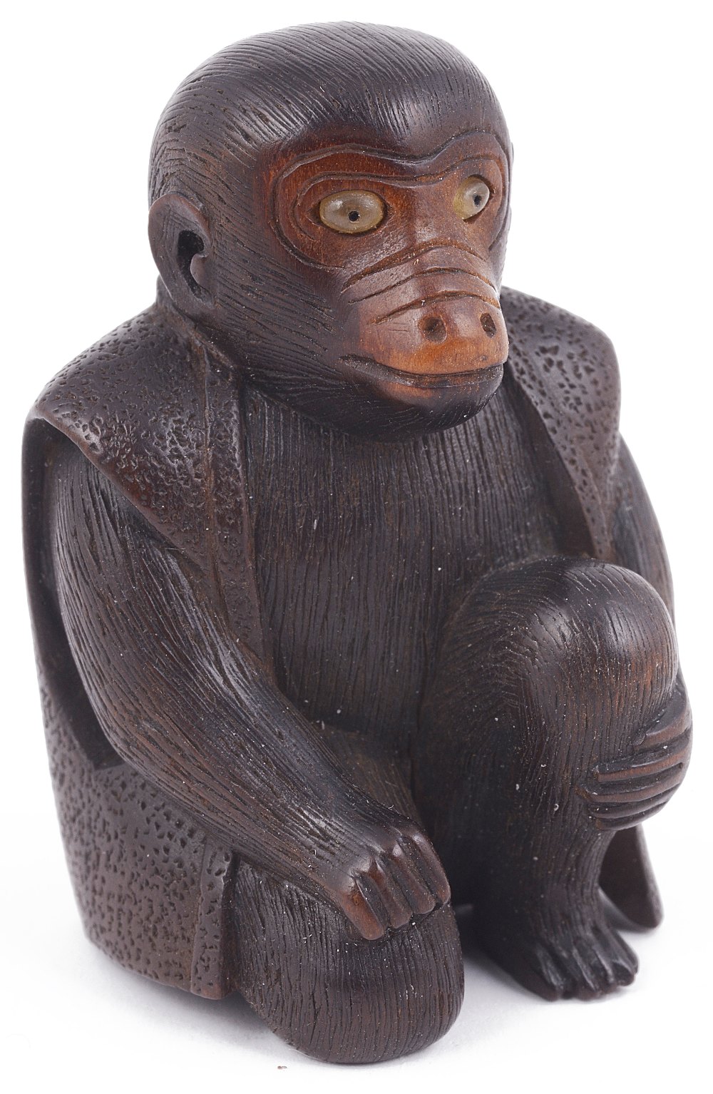 WOOD NETSUKE OF A SEATED PERFORMING MONKEY, CIRCA 1870 wearing a jacket, and with inlaid horn