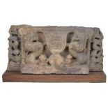 A BUFF SANDSTONE PLINTH FROM AN IMAGE, CENTRAL INDIA, 10TH/11TH CENTURY carved in relief depicting a