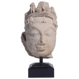 A BUFF SANDSTONE HEAD OF A DEITY, PROBABLY SARNATH REGION, CENTRAL INDIA, 9TH/10TH CENTURY the