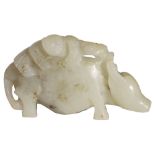 A CHINESE CELADON JADE 'BOY AND BUFFALO' GROUP the beast carved standing four-square with a small