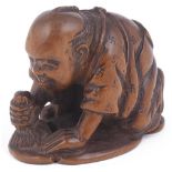 BOXWOOD NETSUKE OF A MAN POLISHING THE CHARACTER KOKORO (HEART), CIRCA 1870 a popular Meiji subject,