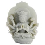 A CHINESE CELADON JADE MULTI-ARMED DIETY seated in front of a lotus-shaped aureol, wearing a long