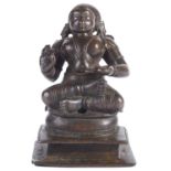 A BRONZE FIGURE OF A TAMIL SAINT, SOUTH INDIA, CIRCA 18TH CENTURY seated in sattvasana on a raised