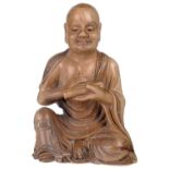 ‡ A CHINESE SOAPSTONE FIGURE OF A LUOHAN, 19TH CENTURY the beige soapstone figure carved seated