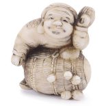 ˜WALRUS IVORY NETSUKE OF THE LUCKY GOD DAIKOKU WITH HIS RICE BALE, CIRCA 1870 unsigned 3.8cm high