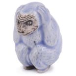 BLUE AND WHITE PORCELAIN NETSUKE OF A MONKEY CLUTCHING ITS EARS, CIRCA 1870 unsigned 4.2cm high