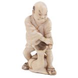 ˜IVORY NETSUKE OF A SAMURAI CONFRONTING A GIANT SNAIL, CIRCA 1870 signed: Tomochika 4.6cm high