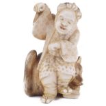 ˜IVORY NETSUKE OF A MAN DANCING WITH A FOX, CIRCA 1870 incised and stained details, signed: Tomonobu