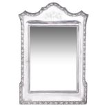 A GEORGE V SILVER-MOUNTED DRESSING TABLE MIRROR, C.S. GREEN & CO., BIRMINGHAM, 1910 shaped oblong,