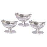 A SET OF THREE GEORGE III SILVER SALT CELLARS, THOMAS WALLIS, LONDON, 1801 pedestal navette shaped