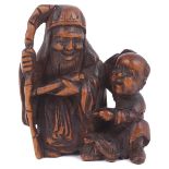 WOOD NETSUKE OF JUROJIN AND KARAKO, CIRCA 1870 with a minogame turtle on the ground between them,