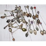 A selection of silver and plated souvenir spoons