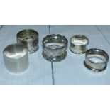 A hallmarked silver napkin rings and 3 others