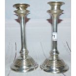 A Hall Marked Silver pair of Art Nouveau period candlesticks, slender turned columns on circular st