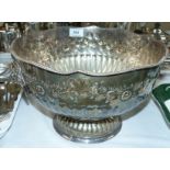 A large silver plated embossed punch bowl with lion mask and ring handles