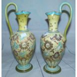 A pair of Doulton Lambeth Slater's Patent baluster ewers in yellow, turquoise and gilt, height 10½"