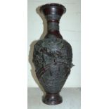 A large oriental bronze vase decorated in high relief with figure of a warrior on a bridge, script