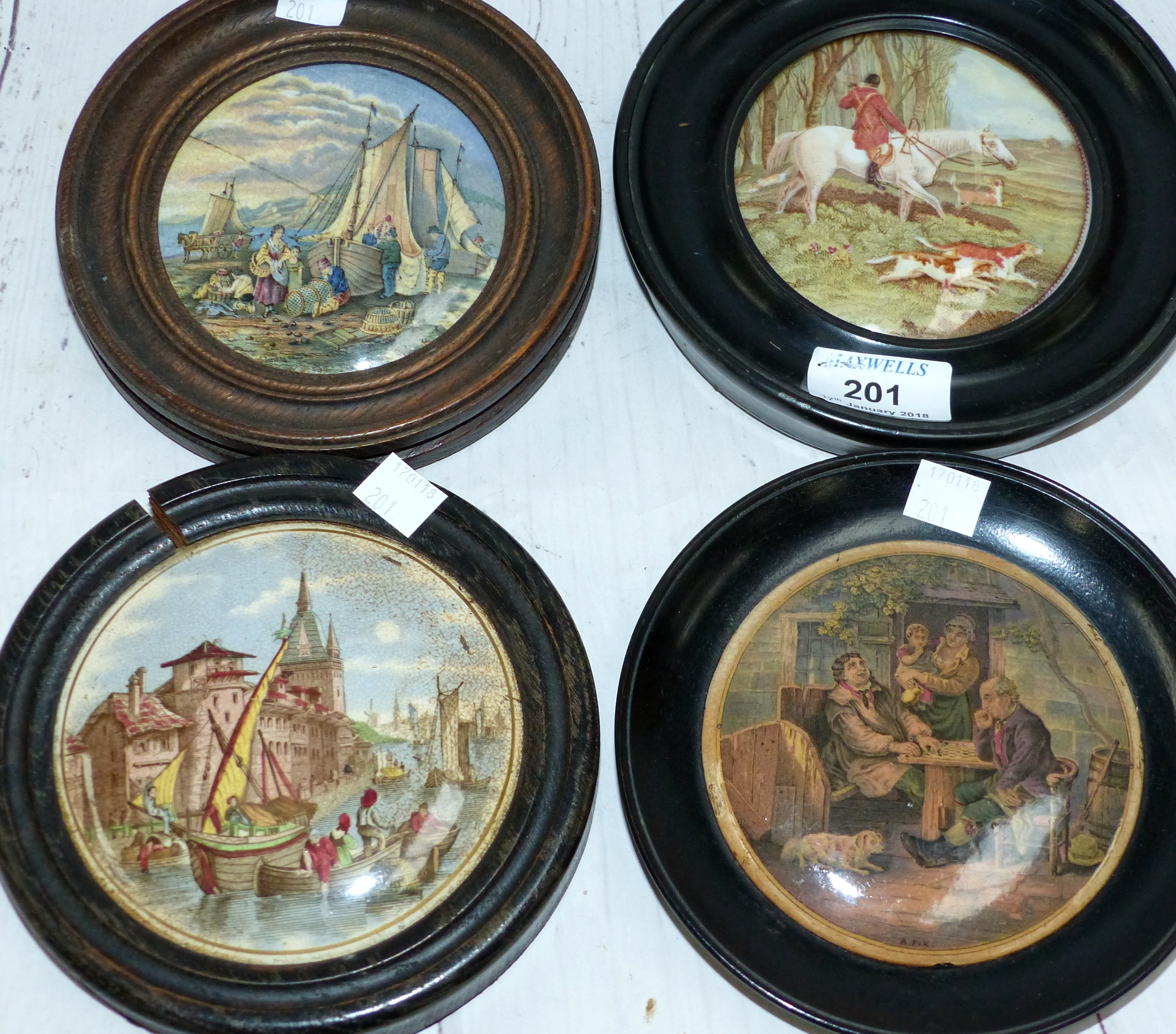 Four 19th century pot lids in ebonised frames: "Fox Hunting"; "A Fix"; "Canal Scene" & "Unloading