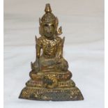 An eastern gold overlaid figure of Buddha, 5"