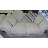 A 2 seater settee in oatmeal upholstery