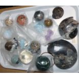 A collection of fossils and various agate and hardstone spheres