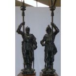 A pair of 19th century cast iron figures of knights in armour with swords and pikes, heights 5'8" (