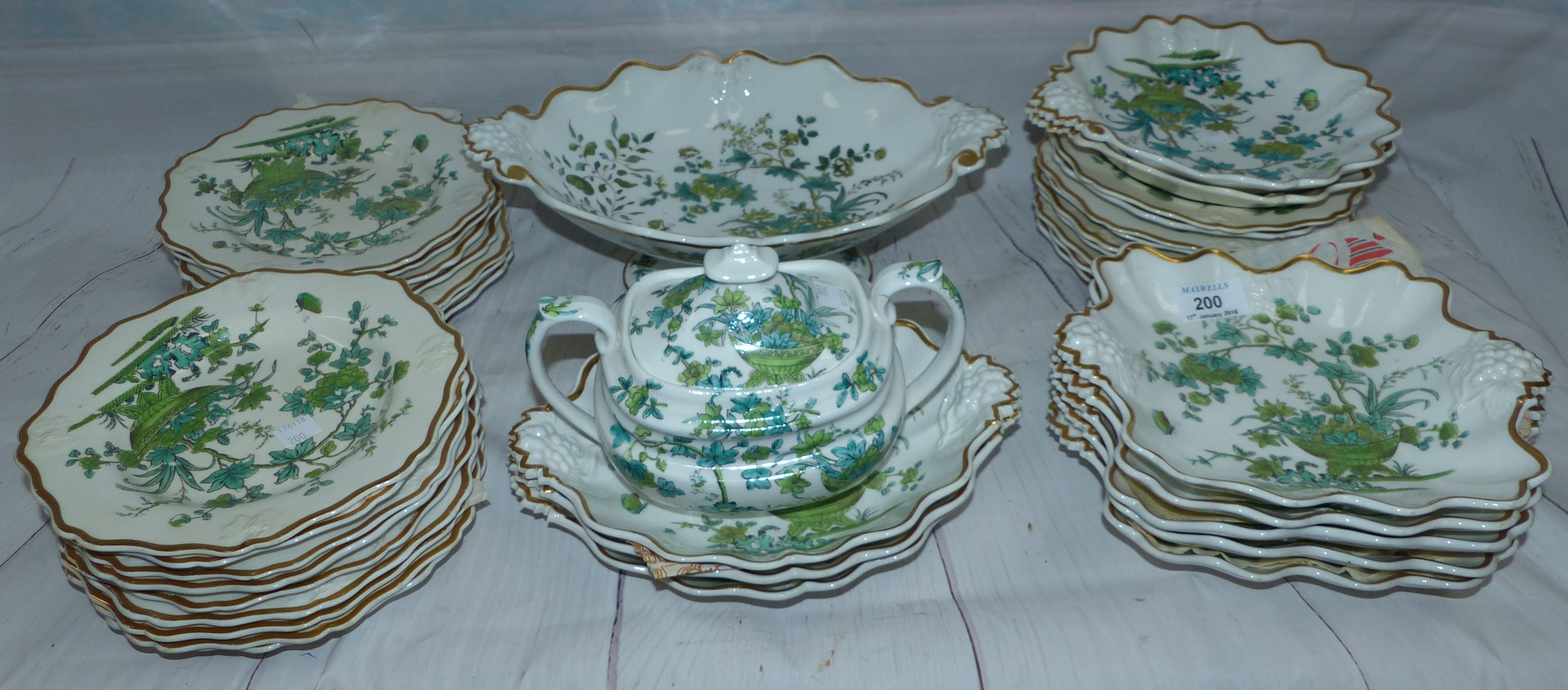 An early 19th century Ridgway dessert service, hand painted in green with flowers in the Chinese