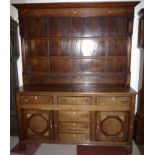 An 18th century oak country made Welsh dresser with geometric inlaid motifs, having 3 height Delft
