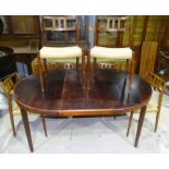 A 1970's rosewood dining suite comprising rounded rectangular table with 2 spare leaves, extended