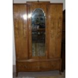 A Queen Anne style figured walnut wardrobe with mirror door and base drawer, by Maples, London