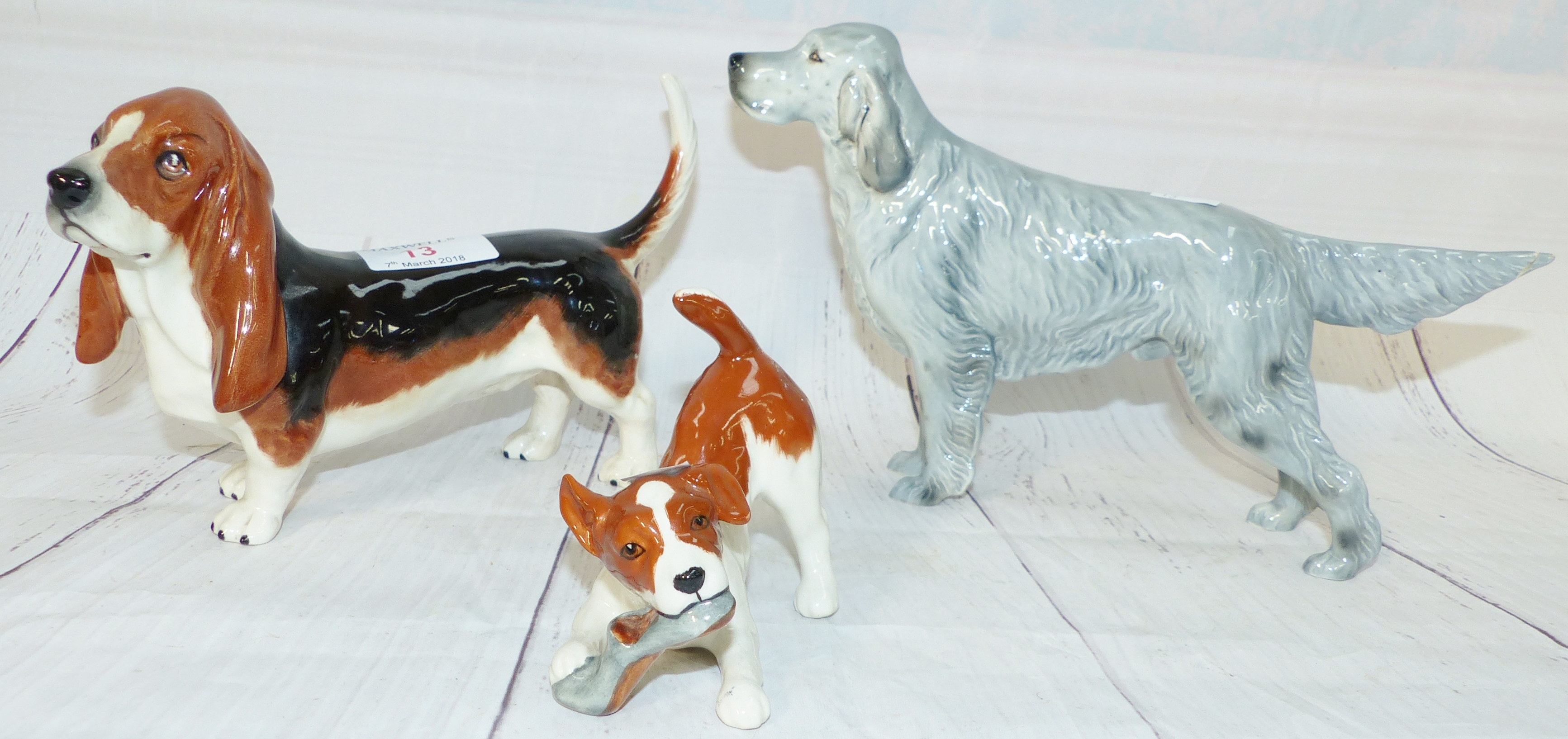 A Beswick china figure of a Basset Hound, a similar figure Bayldone Baronet (tail repaired), another