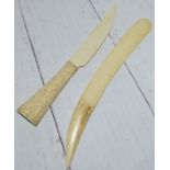 A Inuit bone knife with carved figure to the handle and a bone letter opener