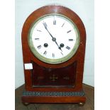 An Inlaid mantle clock with French movement with mahogany case with enamel dial.