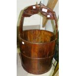 A stained wooden water carrying bucket