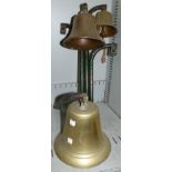 A brass ships bell on bracket; 2 small brass bells on triple wall bracket