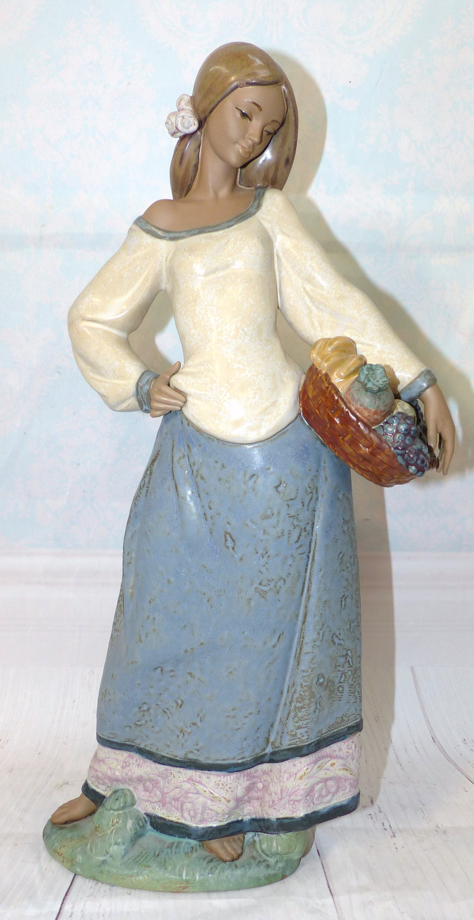 A large Lladro figure - Girl with Basket of Fruit a.f