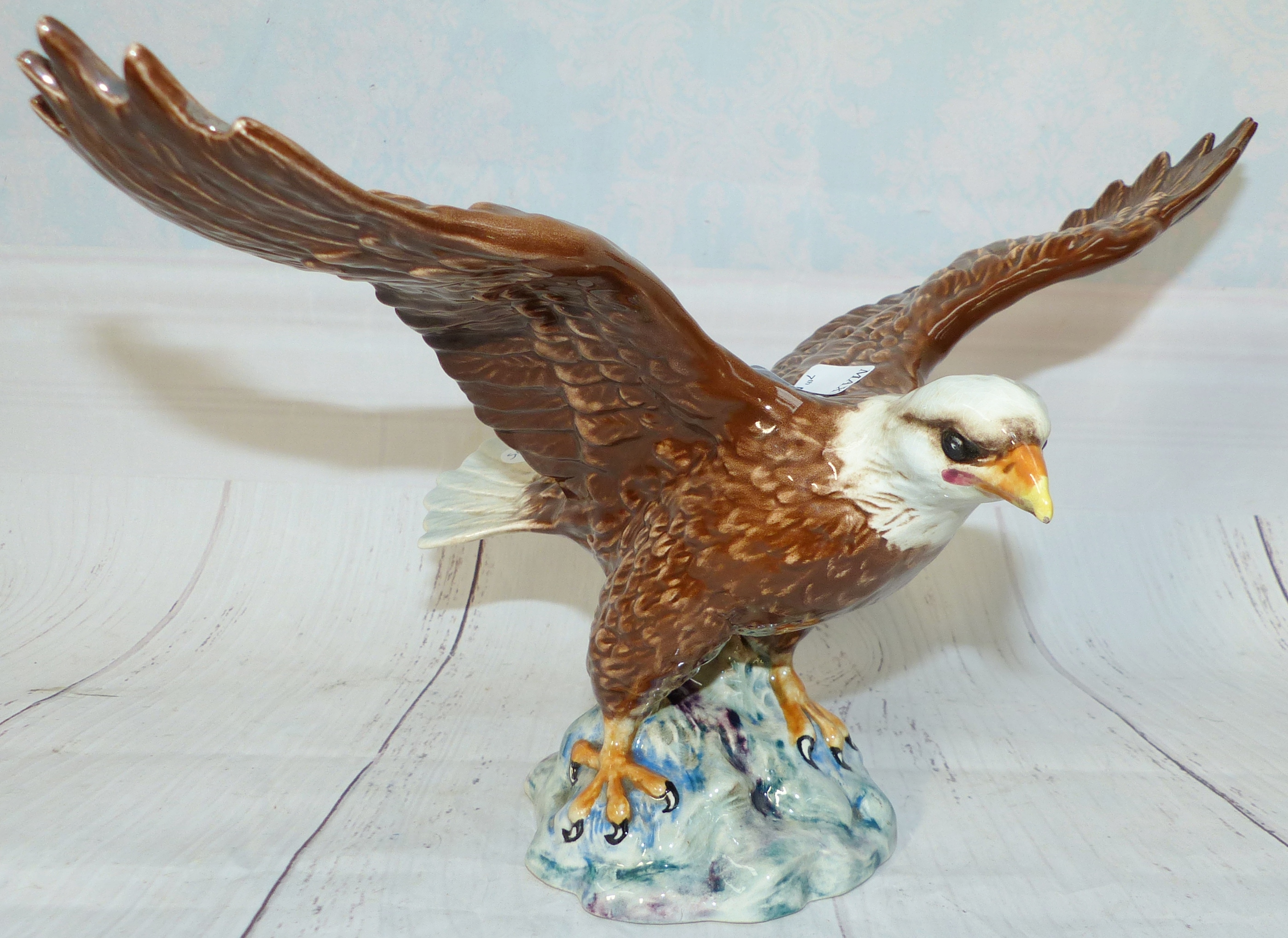 A Beswick pottery figure of an eagle with wings outstretched 13'' across wings