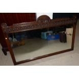 An oak framed Jacobean style wall mirror 39'' x 25'' overall