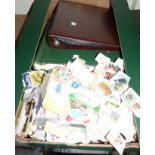 A box of stamp albums and loose stamps