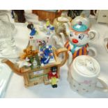 6 Novelty Teapots:- Toy box (with Golly), Alice in Wonderland (tea party), Temple, Party Table/