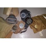 A Services gas mask; a civilian gas mask; a child's gas mask