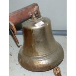 A large brass ship's bell on steel wall bracket height 11'' lettered MAGNIFICAT